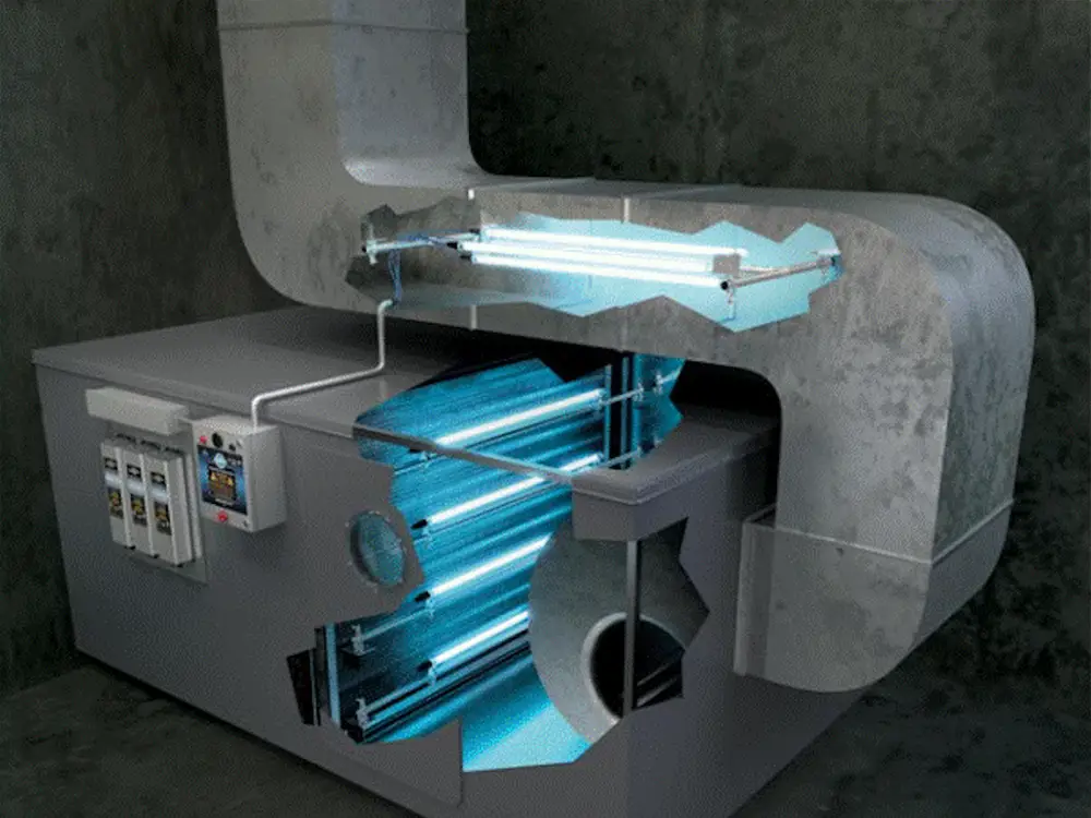 A top-rated duct system in an industrial setting is shown with ultraviolet (UV) lights installed inside. The cutaway view reveals multiple UV lights illuminating the interior, enhancing duct cleaning efficiency. The exterior is gray with a control panel and several switches on the side against a plain, dark wall.