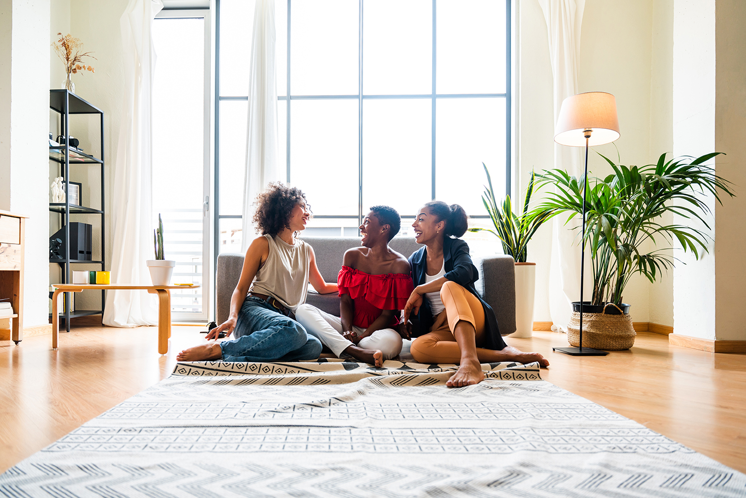 three mixed race hispanic and black women bonding at home